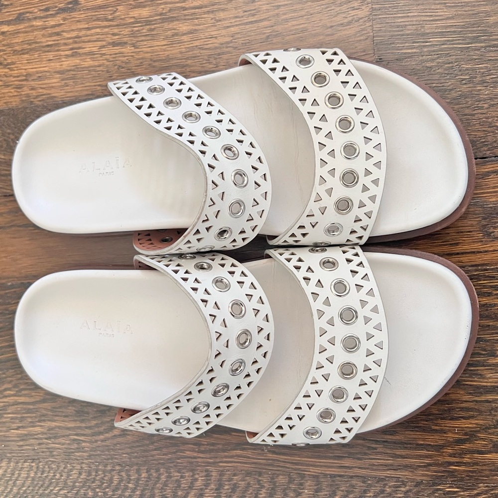 Alaia white leather silver grommet slide sandals